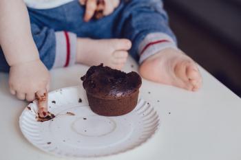 Infant eating cake