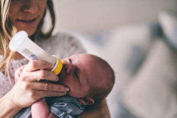 bottle feeding royalty free Photo by Andrew Branch via Unsplash
